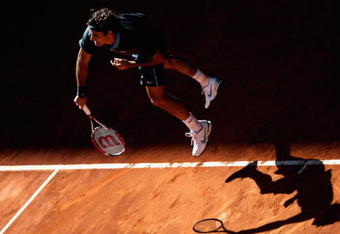 MADRID, SPAIN - MAY 17:  Roger Federer of Switzerland serves against Rafael Nadal of Spain during the Madrid Open Men's Final at the Caja Magica on May 17, 2009 in Madrid, Spain.  (Photo by Clive Brunskill/Getty Images)