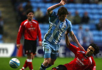 COVENTRY, ENGLAND - APRIL 21:  Anderson De Silva of Barnsley tackles Aron Gunnarsson of Coventry during the Coca-Cola Championship match between Coventry City and Barnsley at the Ricoh Arena on April 21, 2009 in Coventry, England  (Photo by Matthew Lewis/Getty Images)