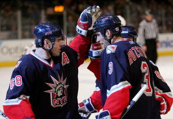 NEW YORK - JANUARY 28:  Michal Rozsival #3 is congratulated by teammate Jaromir Jagr #68 of the New York Rangers after Rozsival scored a goal to put the Rangers up 3-1 in the second period against the Pittsburgh Penguins on January 28, 2006 at Madison Square Garden in New York City.  (Photo by Ezra Shaw/Getty Images)