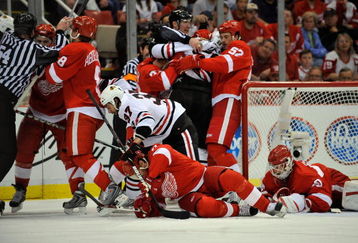 DETROIT - MAY 17:  Officials attempt to seperate players from the Detroit Red Wings and the Chicago Blackhawks as they tussel in front of the Red WIngs net during Game One of the Western Conference Championship Round of the 2009 Stanley Cup Playoffs on May 17, 2009 at Joe Louis Arena in Detroit, Michigan.  (Photo by Jamie Sabau/Getty Images)