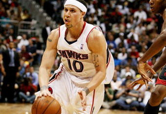 ATLANTA - APRIL 22:  Mike Bibby #10 of the Atlanta Hawks drives around James Jones #22 of the Miami Heat during Game Two of the Eastern Conference Quarterfinals at Philips Arena on April 22, 2009 in Atlanta, Georgia. The Heat defeated the Hawks 108-93. NOTE TO USER: User expressly acknowledges and agrees that, by downloading and/or using this Photograph, user is consenting to the terms and conditions of the Getty Images License Agreement.  (Photo by Doug Benc/Getty Images)