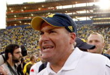 ANN ARBOR, MI - SEPTEMBER 27:  Head coach Rich Rodriguez of the Michigan Wolverines leaves the field with his son Rhett after defeating the Wisconsin Badgers on September 27, 2008 at Michigan Stadium in Ann Arbor, Michigan.  (Photo by Gregory Shamus/Getty Images)
