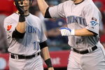 ANAHEIM, CA - MAY 6:  Aaron Hill #2 of the Toronto Blue Jays is greeted at home plate by Marco Scutaro #19 after both scored on Hill's first inning home run against the Los Angeles Angels of Anaheim at Angel Stadium May 6, 2009 in Anaheim, California.  (Photo by Stephen Dunn/Getty Images)