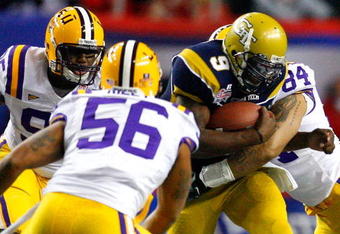 ATLANTA - DECEMBER 31:  Quarterback Josh Nesbitt #9 of the Georgia Tech Yellow Jackets is tackled by Lazarius Levingston #95, Perry Riley #56 and Rahim Alem #84 of the LSU Tigers during the Chick-fil-A Bowl on December 31, 2008 at the Georgia Dome in Atlanta, Georgia.  (Photo by Kevin C. Cox/Getty Images)