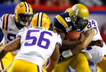 ATLANTA - DECEMBER 31:  Quarterback Josh Nesbitt #9 of the Georgia Tech Yellow Jackets is tackled by Lazarius Levingston #95, Perry Riley #56 and Rahim Alem #84 of the LSU Tigers during the Chick-fil-A Bowl on December 31, 2008 at the Georgia Dome in Atlanta, Georgia.  (Photo by Kevin C. Cox/Getty Images)