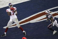 GLENDALE, AZ - FEBRUARY 03:  Wide receiver Plaxico Burress #17 of the New York Giants catches a 13-yard touchdown pass in the fourth quarter over Ellis Hobbs #27 of the New England Patriots during Super Bowl XLII on February 3, 2008 at the University of Phoenix Stadium in Glendale, Arizona.  The Giants defeated the Patriots 17-14.  (Photo by Jim McIsaac/Getty Images)