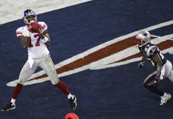 GLENDALE, AZ - FEBRUARY 03:  Wide receiver Plaxico Burress #17 of the New York Giants catches a 13-yard touchdown pass in the fourth quarter over Ellis Hobbs #27 of the New England Patriots during Super Bowl XLII on February 3, 2008 at the University of Phoenix Stadium in Glendale, Arizona.  The Giants defeated the Patriots 17-14.  (Photo by Jim McIsaac/Getty Images)