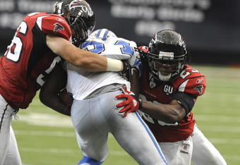 ATLANTA, GA - SEPTEMBER 7: Linebacker Keith Brooking #56 (left)  of the Atlanta Falcons tackles a Detroit Lions runner at the Georgia Dome on September 7, 2008 in Atlanta, Georgia.  (Photo by Al Messerschmidt/Getty Images) 