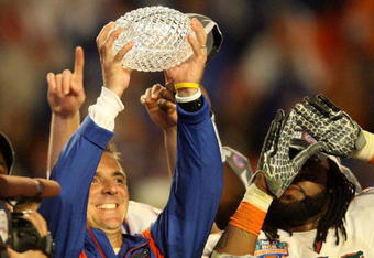 MIAMI - JANUARY 08:  Head coach Urban Meyer of the Florida Gators celebrates with the National Championship trophy after therir 24-14 win against the Oklahoma Sooners during the FedEx BCS National Championship game at Dolphin Stadium on January 8, 2009 in Miami, Florida.  (Photo by Doug Benc/Getty Images)