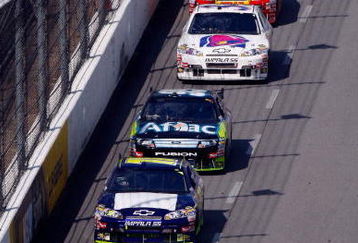 MARTINSVILLE, VA - MARCH 29: Scott Speed, driver of the #82 Red Bull Toyota, races along side Dale Earnhardt Jr., driver of the #88 National Guard/AMP Energy Chevrolet, during the NASCAR Sprint Cup Series Goody's Fast Pain Relief 500 at the Martinsville Speedway on March 29, 2009 in Martinsville, Virginia.  (Photo by John Harrelson/Getty Images)