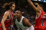 BOSTON - MAY 02:  Glen Davis #11 of the Boston Celtics makes his way through Joakim Noah #13 and Derrick Rose #1 of the Chicago Bulls in Game Seven of the Eastern Conference Quarterfinals during the 2009 NBA Playoffs at TD Banknorth Garden on May 2, 2009 in Boston, Massachusetts. NOTE TO USER: User expressly acknowledges and agrees that, by downloading and or using this photograph, User is consenting to the terms and conditions of the Getty Images License Agreement.  (Photo by Elsa/Getty Images)