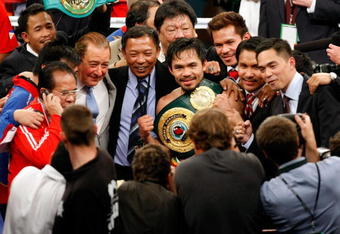 LAS VEGAS - MAY 02:  (M) Manny Pacquiao of the Philippines celebrates after knocking out Ricky Hatton of England in the second round during their junior welterweight title fight at the MGM Grand Garden Arena May 2, 2009 in Las Vegas, Nevada.  (Photo by Ethan Miller/Getty Images)
