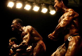 KUTA BALI, INDONESIA - OCTOBER 20:  Athletes compete in the men's 80kg beach body building competition on day three of the 2008 Asian Beach Games at Kuta  Beach on October 20, 2008 in Bali, Indonesia.  (Photo by Ezra Shaw/Getty Images)