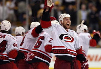 BOSTON - MAY 14:  Joe Corvo #77 of the Carolina Hurricanes celebrates the win in Game Seven of the Eastern Conference Semifinal Round of the 2009 Stanley Cup Playoffs on May 14, 2009 at the TD Banknorth Garden in Boston, Massachusetts. The Hurricanes defeated the Bruins 3-2 in overtime.  (Photo by Elsa/Getty Images)
