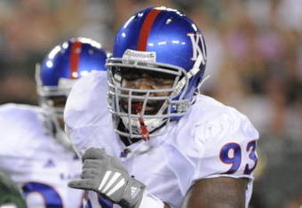 TAMPA, FL - SEPTEMBER 12: Defensive tackle Darius Parish #93 of the Kansas University Jayhawks rushes the pocket against the University of South Florida Bulls at Raymond James Stadium on September 12, 2008 in Tampa, Florida.  (Photo by Al Messerschmidt/Getty Images) 
