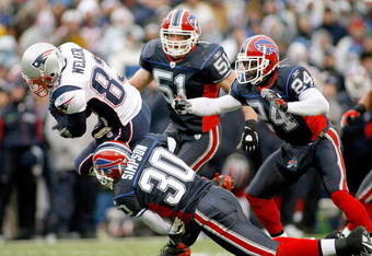 ORCHARD PARK, NY - DECEMBER 28: Wes Welker #83 of the New England Patriots falls forward for a first down ahead of Ko Simpson #30, Paul Posluszny #51 and Terrence McGee #24 of the Buffalo Bills at Ralph Wilson Stadium December 28, 2008 in Orchard Park, New York.  (Photo by Rick Stewart/Getty Images)