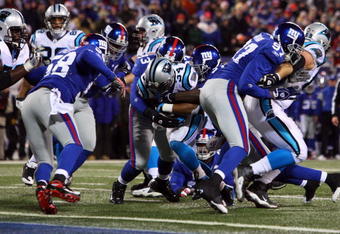 EAST RUTHERFORD, NJ - DECEMBER 21:  Running back DeAngelo Williams #34 of the Carolina Panthers breaks a tackle to score a touchdown against the New York Giants on December 21, 2008 at Giants Stadium in East Rutherford, New Jersey.  (Photo by Jim McIsaac/Getty Images)