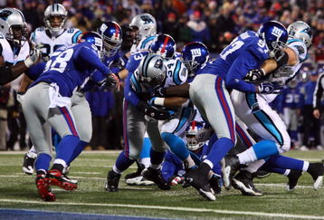 EAST RUTHERFORD, NJ - DECEMBER 21:  Running back DeAngelo Williams #34 of the Carolina Panthers breaks a tackle to score a touchdown against the New York Giants on December 21, 2008 at Giants Stadium in East Rutherford, New Jersey.  (Photo by Jim McIsaac/Getty Images)