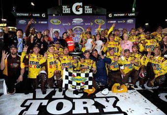 RICHMOND, VA - MAY 02:  Kyle Busch, driver of the #18 Combos Toyota, celebrates in victory lane with his crew after winning the NASCAR Sprint Cup Series Crown Royal Presents the Russ Friedman 400 at Richmond International Raceway on May 2, 2009 in Richmond, Virginia.  (Photo by Rusty Jarrett/Getty Images for NASCAR)
