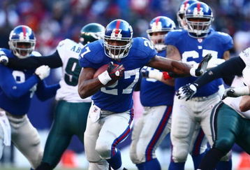 EAST RUTHERFORD, NJ -  JANUARY 11:  Brandon Jacobs #27 of the New York Giants runs the ball against the Philadelphia Eagles during the NFC Divisional Playoff Game on January 11, 2009 at Giants Stadium in East Rutherford, New Jersey.  The Eagles defeated the Giants 23 -11. (Photo by Chris McGrath/Getty Images)