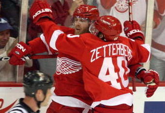 DETROIT - MAY 19:  Dan Cleary #11 and Henrik Zetterberg #40 of the Detroit Red Wings celebrate after Cleary scored a goal in the second period against the Chicago Blackhawks during Game Two of the Western Conference Championship Round of the 2009 Stanley Cup Playoffs on May 19, 2009 at Joe Louis Arena in Detroit, Michigan.  (Photo by Claus Andersen/Getty Images)