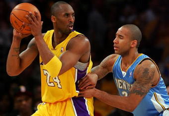 LOS ANGELES, CA - MAY 19:  Kobe Bryant #24 of the Los Angeles Lakers posts up Dahntay Jones #30 of the Denver Nuggets in the first half of Game One of the Western Conference Finals during the 2009 NBA Playoffs at Staples Center on May 19, 2009 in Los Angeles, California. NOTE TO USER: User expressly acknowledges and agrees that, by downloading and or using this photograph, User is consenting to the terms and conditions of the Getty Images License Agreement.  (Photo by Stephen Dunn/Getty Images)