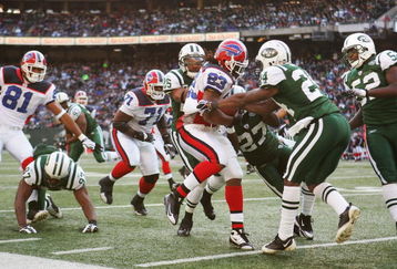 EAST RUTHERFORD, NJ - DECEMBER 14:  Marshawn Lynch #23 of the Buffalo Bills attempts to elude the tackle of Darrelle Revis #24 of the New York Jets during their game on December 14, 2008 at Giants Stadium in East Rutherford, New Jersey.  (Photo by Al Bello/Getty Images)