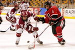 BOSTON - FEBRUARY 13:  Jon Pelle #11 of the Harvard Crimson battles for the puck against Louis Liotti #5 of the Northeastern Huskies during the consolation game of the 54th annual Beanpot tournament on February  13, 2006 at the TD Banknorth Garden in Boston, Massachusetts.  (Photo by Jim McIsaac/Getty Images)