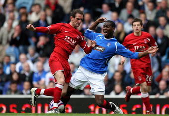 GLASGOW, SCOTLAND - MAY 16: Maurice Edu of Rangers is tackled by Mark Kerr of Aberdeen during the Scottish Premier League match between Rangers and Aberdeen at Ibrox Stadium on May 16, 2009 in Glasgow, Scotland.  (Photo by Jeff J Mitchell/Getty Images)
