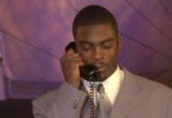 21 Apr 2001:  Michael Vick speaks to representatives from the Atlanta Falcons before the Falcons selected Vick first in the NFL Draft at Madison Square Garden in New York City. Mandatory Credit: Ezra Shaw/ALLSPORT