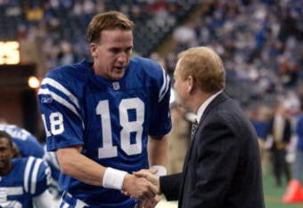 23 Dec 2001: Quarterback Peyton Manning #18 of the Indianapolis Colts shakes hands with general manager Bill Polian during warm-ups before the game against the New York Jets at the RCA Dome in Indianapolis, Indiana. The Jets won 29-28. DIGITAL IMAGE. Mandatory Credit: Ron Hoskins/Getty Images
