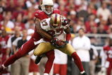 GLENDALE, AZ - NOVEMBER 25:  Cornerback Walt Harris #27 of the San Francisco 49ers intercepts a pass intended for wide receiver Larry Fitzgerald #11 of the Arizona Cardinals on November 25, 2007 at University of Phoenix Stadium in Glendale, Arizona.   (Photo by Stephen Dunn/Getty Images)