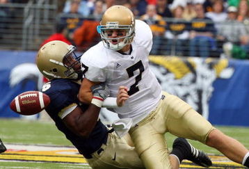BALTIMORE - NOVEMBER 15:  Corey Johnson #5 of the Navy Midshipmen forces a fumble by quarterback Jimmy Clausen #7 of the Notre Dame Fighting Irish on November 15, 2008 at M&T Bank Stadium in Baltimore, Maryland.  (Photo by Jim McIsaac/Getty Images)