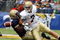 BALTIMORE - NOVEMBER 15:  Corey Johnson #5 of the Navy Midshipmen forces a fumble by quarterback Jimmy Clausen #7 of the Notre Dame Fighting Irish on November 15, 2008 at M&T Bank Stadium in Baltimore, Maryland.  (Photo by Jim McIsaac/Getty Images)