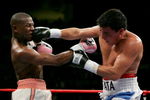 LAS VEGAS - NOVEMBER 04:  Carlos Baldomir (R) of Argentina connects to the face of Floyd Mayweather during their WBC Welterweight Championship fight at the Mandalay Bay Events Center November 4, 2006 in Las Vegas, Nevada.  (Photo by Ethan Miller/Getty Images)