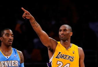 LOS ANGELES, CA - MAY 19:  Kobe Bryant #24 of the Los Angeles Lakers points as he stands with J.R. Smith #1 of the Denver Nuggets in the second half of Game One of the Western Conference Finals during the 2009 NBA Playoffs at Staples Center on May 19, 2009 in Los Angeles, California. NOTE TO USER: User expressly acknowledges and agrees that, by downloading and or using this photograph, User is consenting to the terms and conditions of the Getty Images License Agreement.  (Photo by Kevork Djansezian/Getty Images)