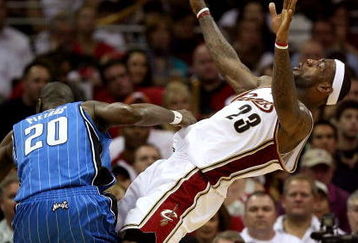 CLEVELAND - MAY 20: Mickael Pietrus #20 of the Orlando Magic commits an offensive foul against LeBron James #23 of the Cleveland Cavaliers in Game One of the Eastern Conference Finals during the 2009 Playoffs at Quicken Loans Arena on May 20, 2009 in Cleveland, Ohio. NOTE TO USER: User expressly acknowledges and agrees that, by downloading and or using this photograph, User is consenting to the terms and conditions of the Getty Images License Agreement  (Photo by Elsa/Getty Images)