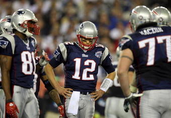GLENDALE, AZ - FEBRUARY 03:  Tom Brady #12 of the New England Patriots huddles with his team during Super Bowl XLII against the New York Giants on February 3, 2008 at the University of Phoenix Stadium in Glendale, Arizona.  (Photo by Donald Miralle/Getty Images)