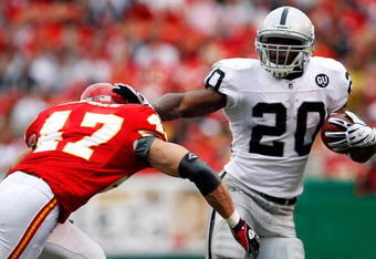 KANSAS CITY, MO - SEPTEMBER 14:  Darren McFadden #20 of the Oakland Raiders carries the ball as Jon McGraw #47 of the Kansas City Chiefs defends during the first half fo the game on September 14, 2008 at Arrowhead Stadium in Kansas City, Missouri.  (Photo by Jamie Squire/Getty Images)