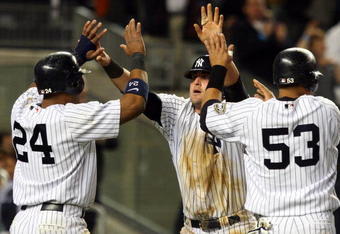 NEW YORK - MAY 19:  Robinson Cano #24, Francisco Cervelli #29, and Melky Cabrera #53 of the New York Yankees celebrate after scoring on tammate Derek Jeter's #2 (not pictured) double in the seventh inning against the Baltimore Orioles at Yankee Stadium May 19, 2009 in the Bronx borough of New York City.  (Photo by Jim McIsaac/Getty Images)