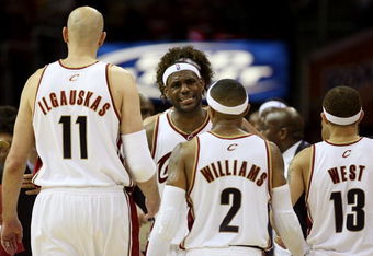 CLEVELAND - MAY 20:  LeBron James #23 reacts after a play with teammates Zydrunas Ilgauskas #11, Mo Williams #2 and Delonte West #13 of the Cleveland Cavaliers against the Orlando Magic in Game One of the Eastern Conference Finals during the 2009 Playoffs at Quicken Loans Arena on May 20, 2009 in Cleveland, Ohio. NOTE TO USER: User expressly acknowledges and agrees that, by downloading and or using this photograph, User is consenting to the terms and conditions of the Getty Images License Agreement  (Photo by Elsa/Getty Images)