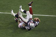 GLENDALE, AZ - FEBRUARY 03: Quarterback Tom Brady #12 of the New England Patriots lies on his back after being sacked by defensive end Michael Strahan #92 of the New York Giants in the third quarter during Super Bowl XLII on February 3, 2008 at the University of Phoenix Stadium in Glendale, Arizona. (Photo by Doug Pensinger/Getty Images)