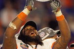 MIAMI - JANUARY 08:  Brandon Spikes #51 of the Florida Gators holds up the winning trophy after the FedEx BCS National Championship Game against the Oklahoma Sooners at Dolphin Stadium on January 8, 2009 in Miami, Florida.  (Photo by Eliot J. Schechter/Getty Images)