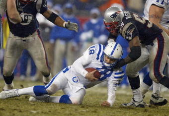 FOXBORO, MA - JANUARY 18:  Linebacker Willie McGinest #55 of the New England Patriots sacks quarterback Peyton Manning #18 of the Indianapolis Colts in the AFC Championship Game on January 18, 2004 at Gillette Stadium in Foxboro, Massachusetts.  (Photo by Al Bello/Getty Images)