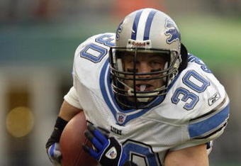SEATTLE - NOVEMBER 16:  Fullback Cory Schlesinger #30 of the Detroit Lions runs the football during the game against the Seattle Seahawks on November 16 2003 at Seahawks Stadium in Seattle, Washington. The Seahawks defeated the Lions 35-14. (Photo by Otto Greule Jr/Getty Images) 