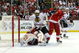 DETROIT - MAY 19: Dustin Byfuglien #33 of the Chicago Blackhawks falls down in the crease as he got tied up with goalie Chris Osgood #30 and Niklas Kronwall #55 (R) of the Detroit Red Wings during Game Two of the Western Conference Championship Round of the 2009 Stanley Cup Playoffs on May 19, 2009 at Joe Louis Arena in Detroit, Michigan. (Photo by Dave Sandford/Getty Images)