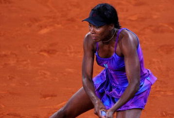 MADRID, SPAIN - MAY 12:  Venus Williams of the US slides to play a backhand to Alisa Kleybanova of Russia in her second round match during the Madrid Open tennis tournament at the Caja Magica on May 12, 2009 in Madrid, Spain.  (Photo by Jasper Juinen/Getty Images)