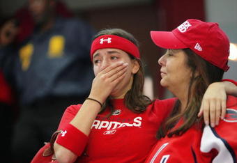WASHINGTON - APRIL 22:  A disappointed fan of the Washington Capitals comes to tears with a overtime loss against the Philadelphia Flyers during game seven of the Eastern Conference Quarterfinals of the 2008 NHL Stanley Cup Playoffs on April 22, 2008 at the Verizon Center in Washington,  DC.  The Flyers won 3-2 in overtime. (Photo by Len Redkoles/Getty Images)