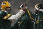 GREEN BAY, WI - JANUARY 12:  Quarterback Brett Favre #4 of the Green Bay Packers shakes hands with running backs coach Edgar Bennett against the Seattle Seahawks during the NFC divisional playoff game on January 12, 2008 at Lambeau Field in Green Bay, Wisconsin. The Packers defeated the Seahawks 42-20 to advance to the NFC championship game.  (Photo by Jonathan Daniel/Getty Images)