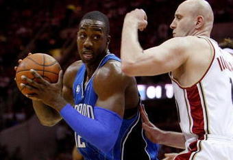 CLEVELAND - MAY 20:  Dwight Howard #12 of the Orlando Magic drives to the hoop against Zydrunas Ilgauskas #11 of the Cleveland Cavaliers in Game One of the Eastern Conference Finals during the 2009 Playoffs at Quicken Loans Arena on May 20, 2009 in Cleveland, Ohio. NOTE TO USER: User expressly acknowledges and agrees that, by downloading and or using this photograph, User is consenting to the terms and conditions of the Getty Images License Agreement  (Photo by Gregory Shamus/Getty Images)